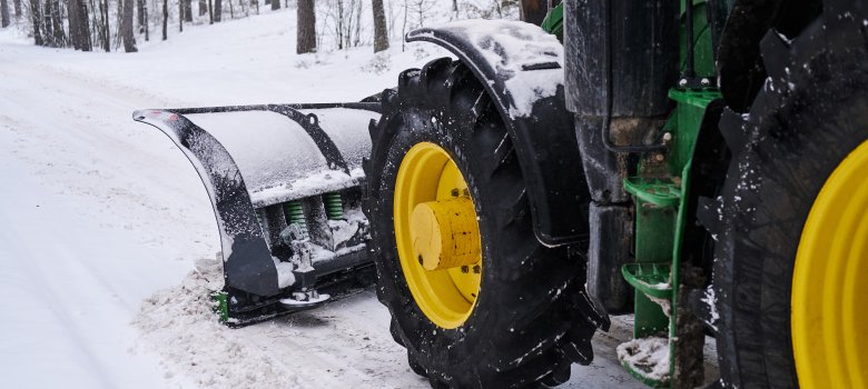 Cleaning machine is removing snow from road