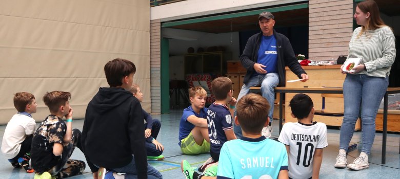 Ein Mann und eine Frau, Kinder sitzen auf dem Boden