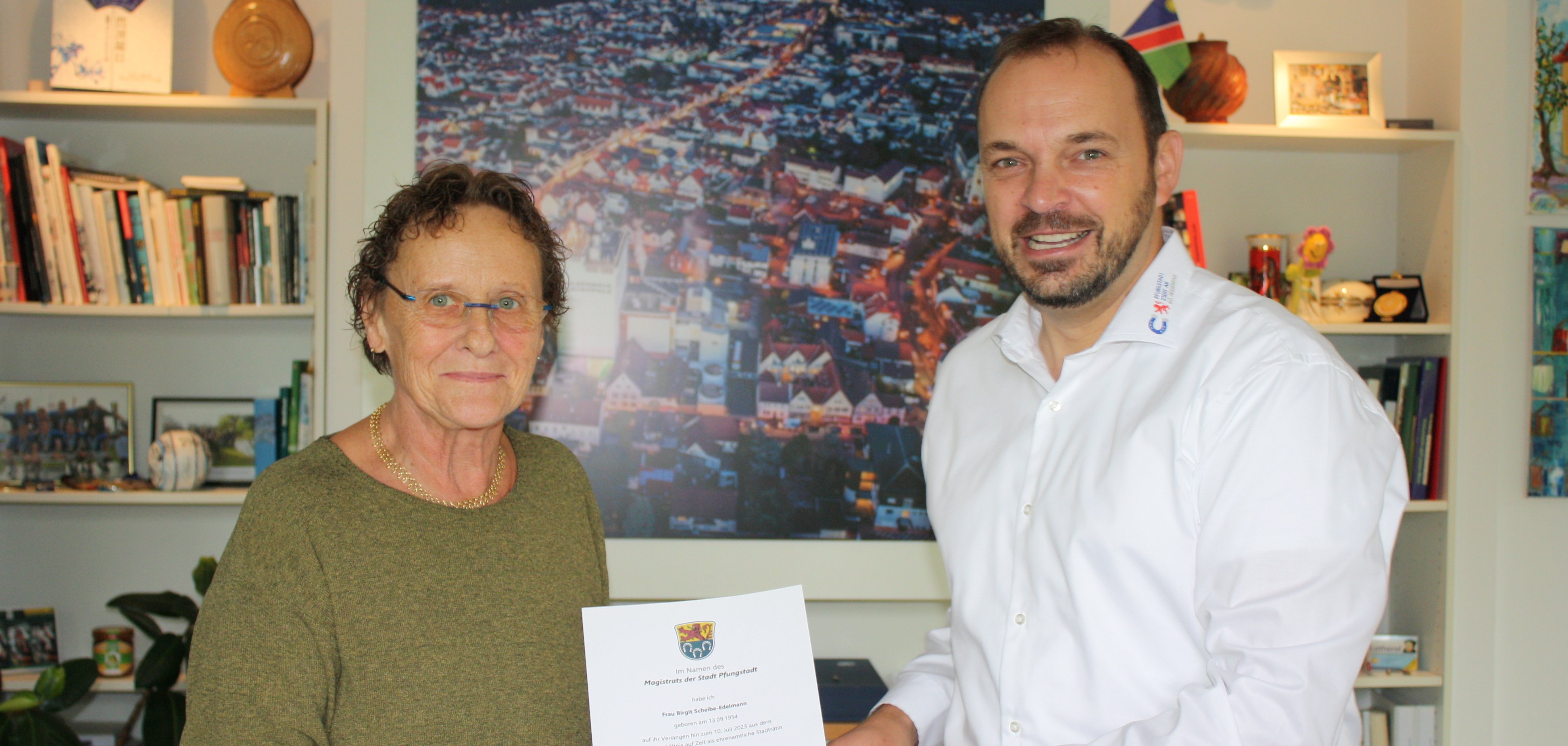 Bürgermeister und Birgit Scheibe-Edelmann mit Urkunde